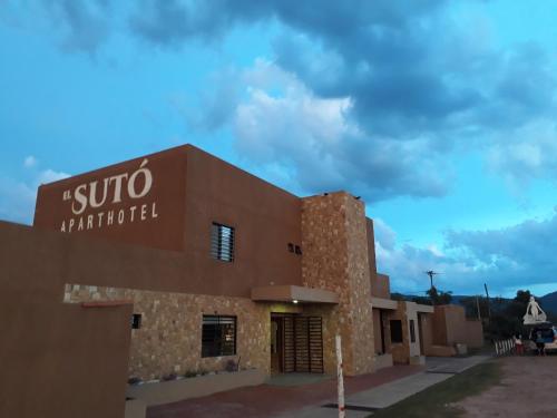 a building with a sign on the side of it at El Suto Apart Hotel in San José de Chiquitos