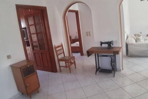 a living room with a table and a mirror at Sotirias hοuse in Symi