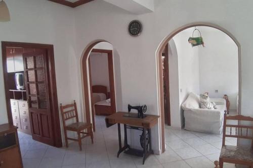 a living room with two mirrors and a couch at Sotirias hοuse in Symi