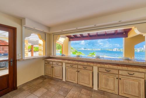 a kitchen with a large window with a view of the ocean at Villa Terre Azure in Les Terres Basses