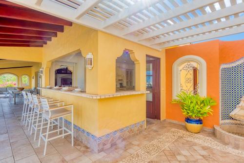 a patio with a bar in a home with orange walls at Villa Terre Azure in Les Terres Basses