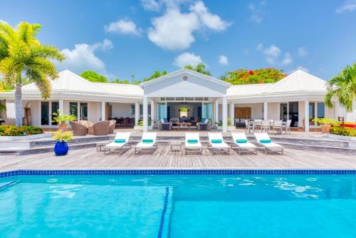 a villa with a swimming pool and a house at Villa Lotus in Marigot