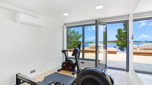a house with a gym with a view of the ocean at Villa Enjoy in Les Terres Basses