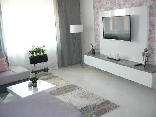a living room with a tv on a wall at Ubytování U Jany in Zaječí