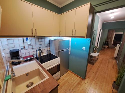a kitchen with a blue refrigerator in a room at Billie's guest house in Iraklitsa