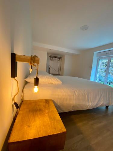- une chambre avec un lit doté d'une lampe et d'une table dans l'établissement Ty Guenhaël petite maisonnette avec extérieur intra-muros proche port de Vannes, à Vannes