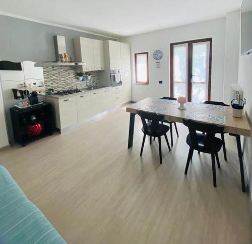 a kitchen with a table and chairs in a room at Casa Azalea in Colico