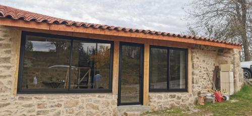 a house with large glass windows on it at Le Pamaro in La Chapelle-dʼAurec