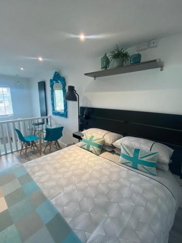 a bedroom with a large bed with blue and white pillows at Studio Tavros in Bristol