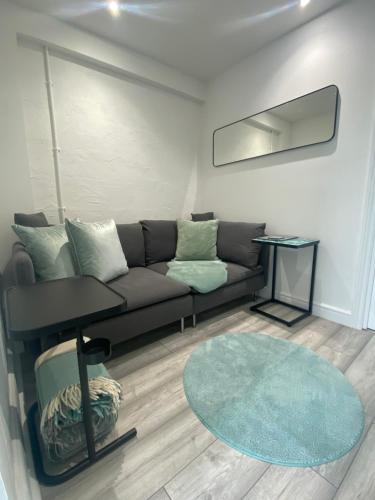 a living room with a couch and a rug at Studio Tavros in Bristol