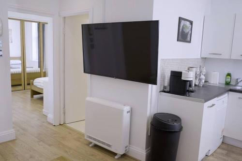 a living room with a flat screen tv on a wall at Apartment in West Yorkshire 3 in Keighley