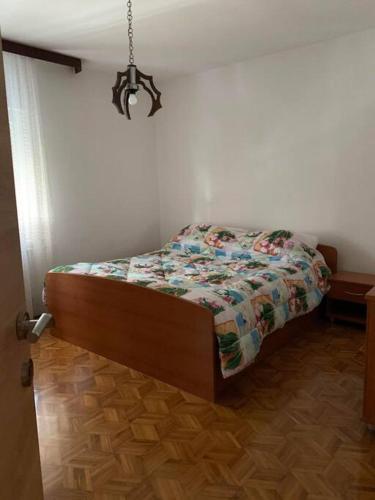 a bedroom with a bed with a quilt on it at Apartment Chie in Izola