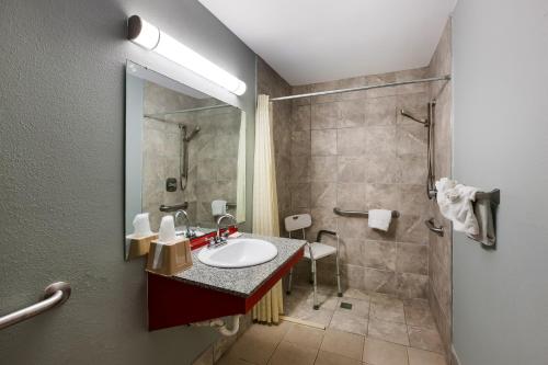 a bathroom with a sink and a shower at Knights Inn Fayetteville - Fort Bragg in Fayetteville