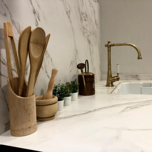 a kitchen counter with wooden spoons and potted plants at URANDIA Alojamiento Rural in Arbizu