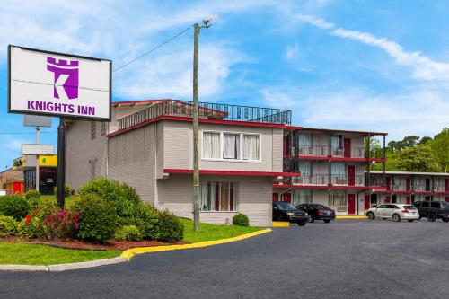 a hotel with a sign in front of a parking lot at Knights Inn Fayetteville - Fort Bragg in Fayetteville