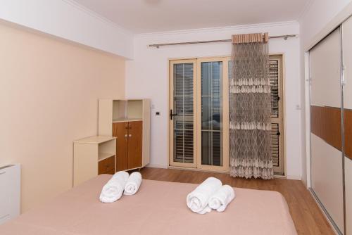 ein Schlafzimmer mit einem Bett mit weißen Handtüchern darauf in der Unterkunft Tirana Central Exclusive in Tirana
