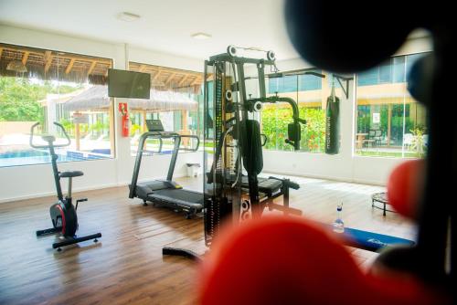 a gym with treadmills and exercise bikes in a room at Na Morada dos Milagres, condomínio Morada do Toque in São Miguel dos Milagres