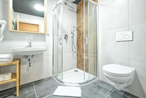 a bathroom with a shower and a toilet and a sink at Restaurace a Penzion Praha in Dolní Dunajovice
