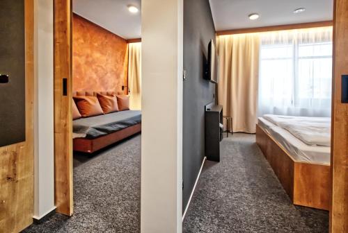 a hotel room with a bed and a window at Restaurace a Penzion Praha in Dolní Dunajovice
