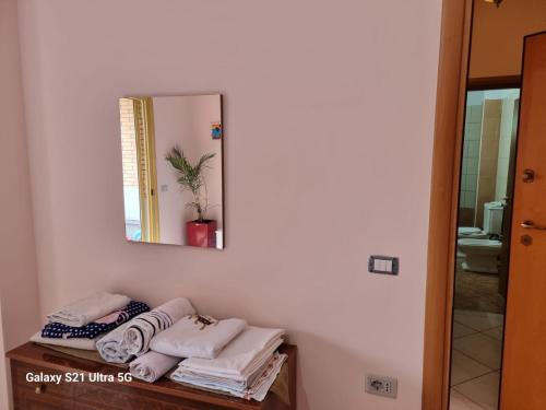 La salle de bains est pourvue d'un miroir et de serviettes sur une table. dans l'établissement Relax Apartment 3, à Vlorë