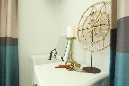 a white shelf with a fan and a lamp on it at Apartmani Freedom place in Jagodina