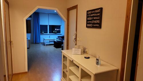 a room with a table with a sign on the wall at Laksevåg Apartment in Bergen