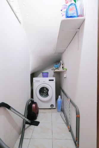 a laundry room with a washing machine in a room at Aeolian Retreats - Rural Villa in Moudhros