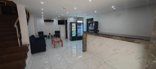 a lobby of a hotel with a counter and a living room at La Cubana Hotel & Suites in Colón