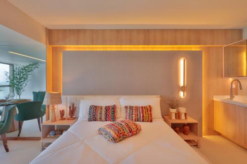 a bedroom with a white bed with two pillows on it at HY Apartments & Hotels in Recife