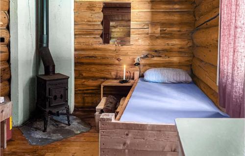 a bedroom with a bed and a wood stove at Cozy Home In Vinstra With Kitchen in Vinstra
