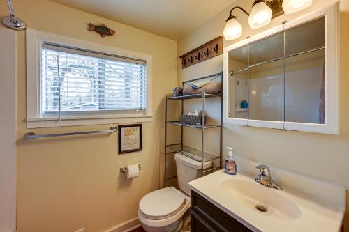 a bathroom with a toilet and a sink and a window at Pet-Friendly Vacation Rental Cabin in Whittier in Whittier