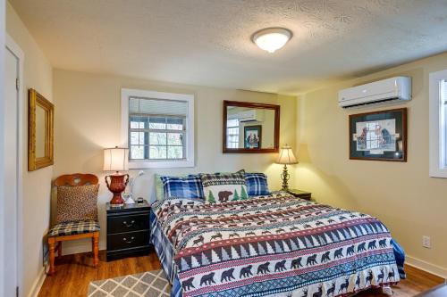 a bedroom with a bed and a chair and a window at Whittier Vacation Rental Cabin Pets Welcome! in Whittier