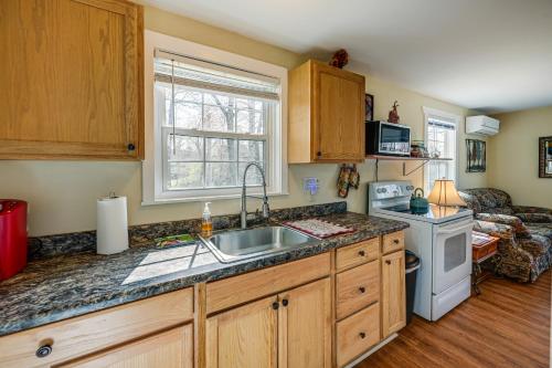 a kitchen with a sink and a stove at Whittier Vacation Rental Cabin Pets Welcome! in Whittier
