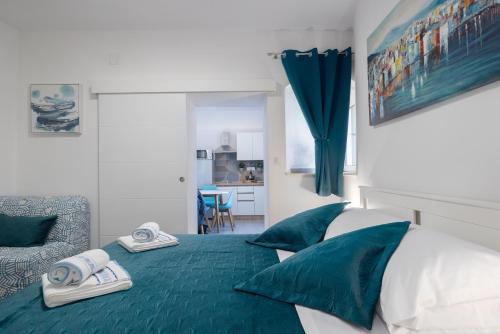 a bedroom with a bed with towels on it at Harmony Apartments in Split
