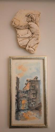 a painting of a house on a wall at Old Town Apartment in Omiš