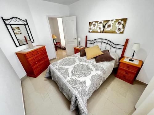 a bedroom with a bed and a dresser and a mirror at Casa Lucy in Garachico