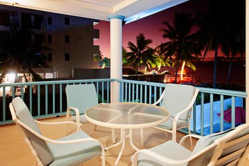 a patio with a table and chairs on a balcony at Marlin House in Nadi