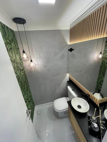 a bathroom with a toilet and a sink at Safira in Meia Praia