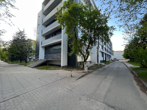 an empty street in front of a building at Cozy apartment in Zverynas in Vilnius