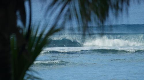 a wave in the ocean with at Ocean Escape Resort & Spa in Rarotonga