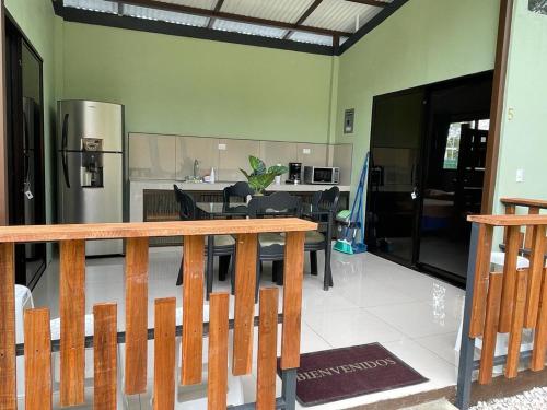 a kitchen and dining room with a table and a refrigerator at Casa Black Chaini in Puerto Viejo