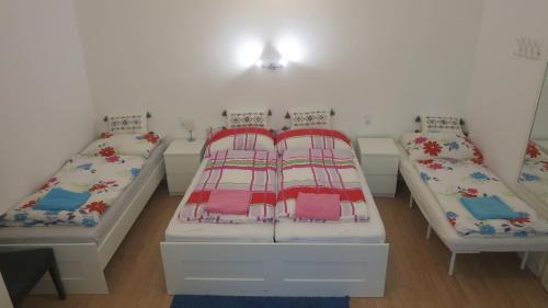 two beds in a room with white walls at Apartments Johann in Vienna