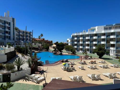 a swimming pool with lounge chairs and a hotel at Dreams vacation tenerife in San Miguel de Abona