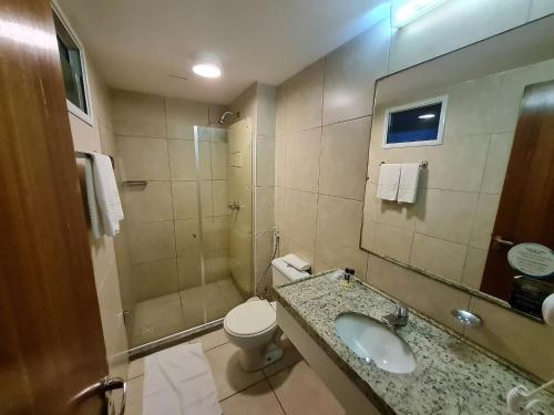 a bathroom with a sink and a toilet and a shower at Pacific Flat da Miramar in Tambaú