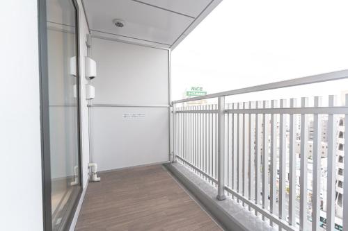 a corridor of a building with a balcony at i-rent京急蒲田 in Tokyo