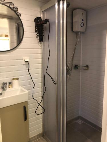 a bathroom with a shower with a camera on the wall at Lemon Tiny House in Antalya