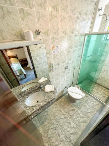 a bathroom with a sink and a toilet at Villa'l Mare Hotel in Maresias