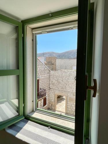 an open window with a view of a building at Sea La Vie in Pag