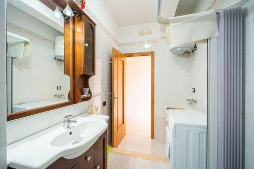 a bathroom with a sink and a mirror at SEAFRONT SUITE 5 Stars - Comfortable Apartment in Marina di Strongoli