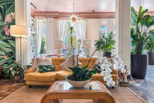 a living room with a couch and some plants at The Savoy Hotel & Beach Club in Miami Beach